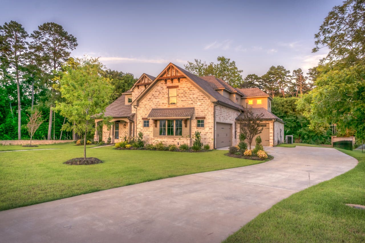 Sacramento home with a well-lit driveway and walkway at dusk, showing how permanent LED outdoor lights illuminate the path from the street to the front door for safety and curb appeal