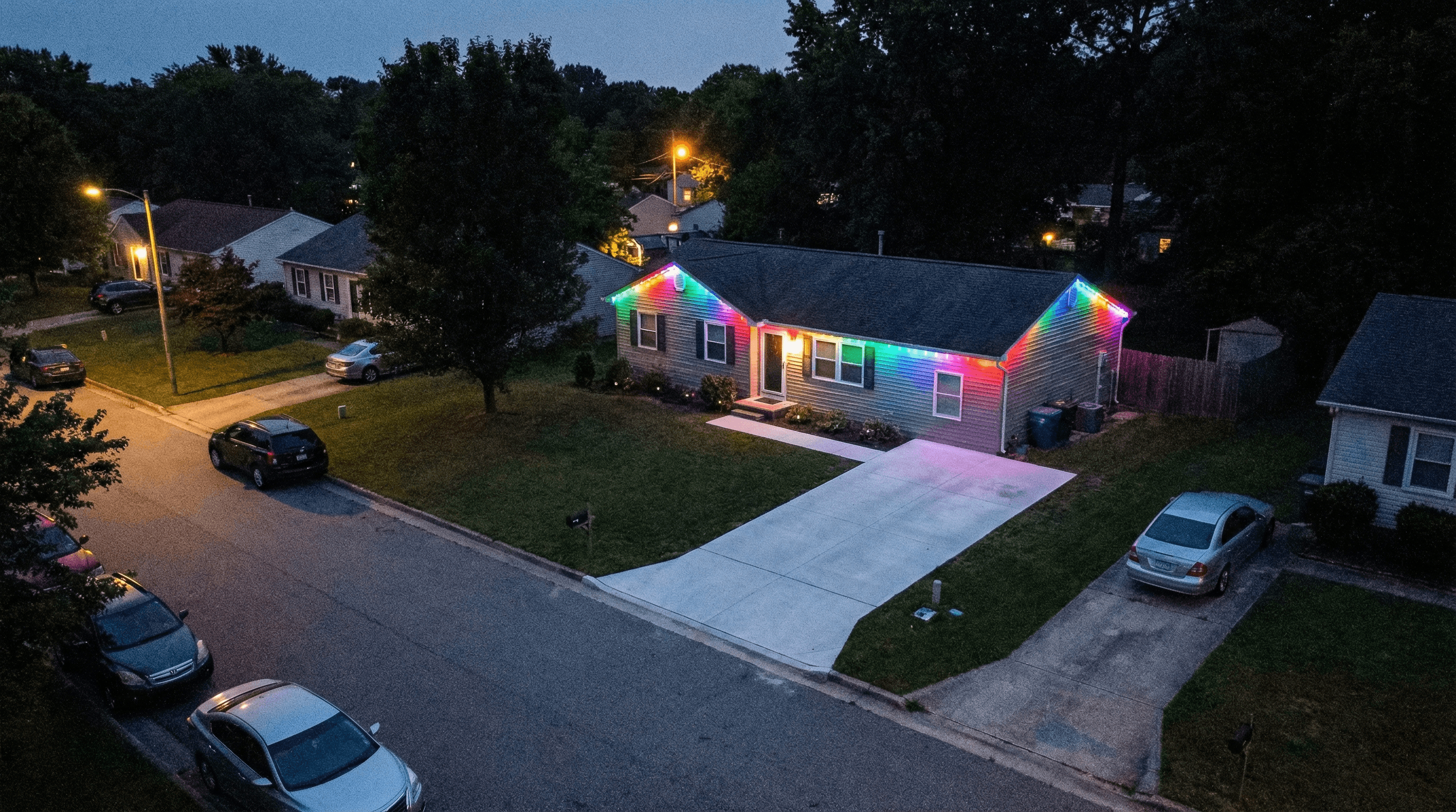 Ranch home aerial view with rainbow trim lighting