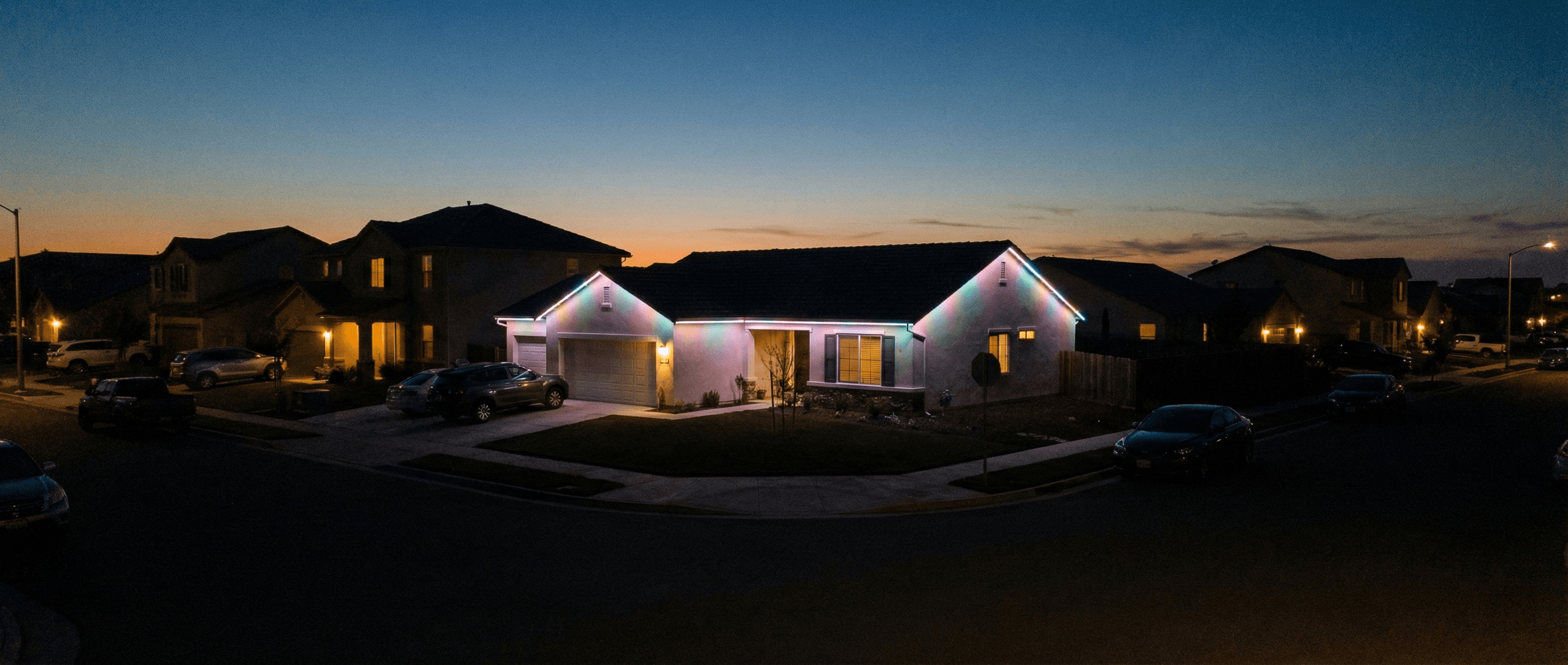 Ranch home with colorful RGB roofline lighting at night