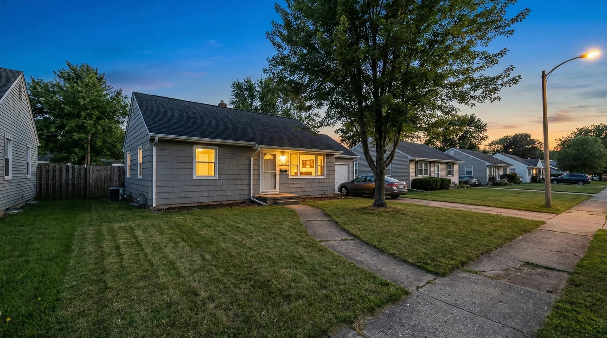 Cape cod home at dusk before lighting installation