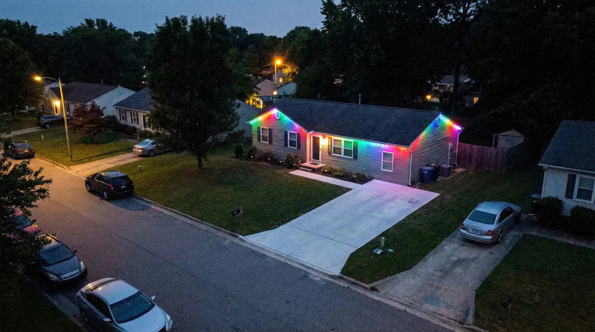 Ranch home aerial view with rainbow trim lighting