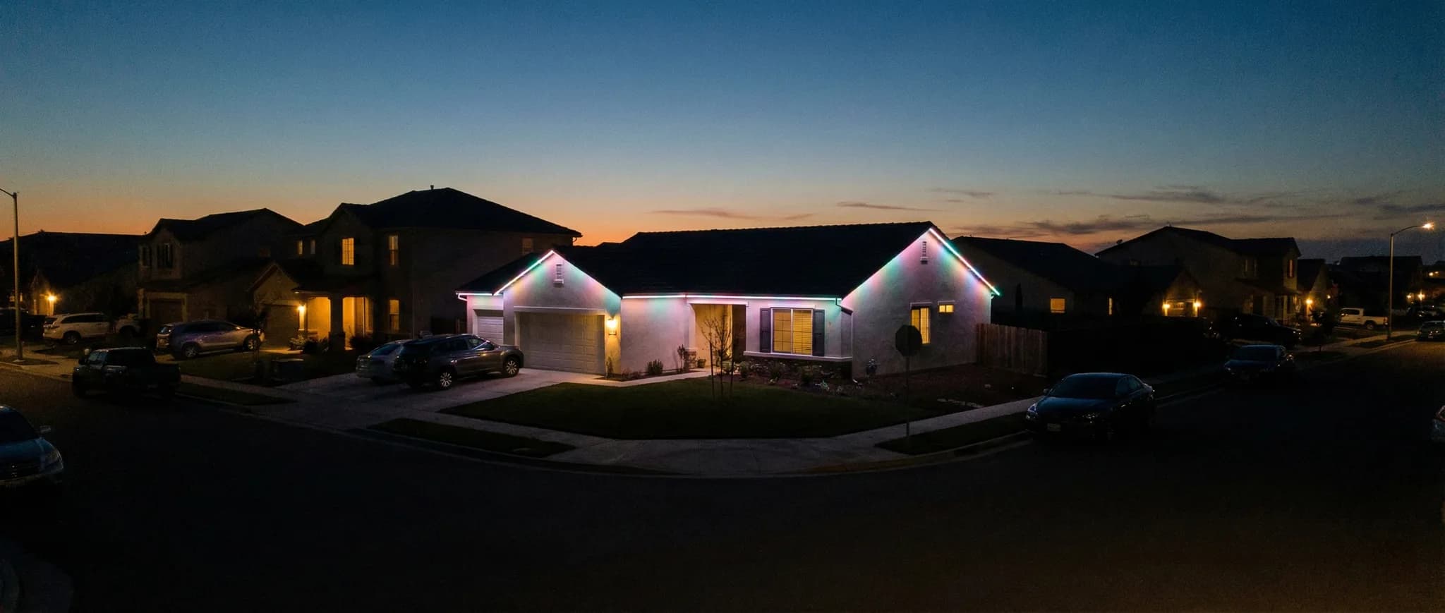 Ranch home with colorful RGB roofline lighting at night